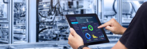 Smart industry control concept.Hands holding tablet on blurred a