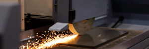 Metal plate grinding process on industrial surface grinding machine. Selective focus.