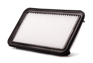 Flat engine air filter in a plastic case, spare part isolated on a white background
