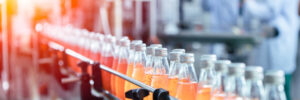 Drink factory production line fruit juice beverage product at conveyor belt.