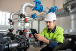 Asian male industrial engineer working inspect water systems